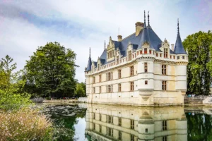 Azay‑le‑Rideau castle mirrored in calm moat under cloudy sky