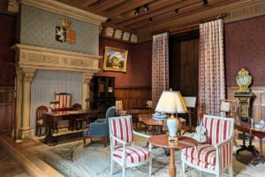 Ornate salon at Azay‑le‑Rideau with striped chairs and mantel