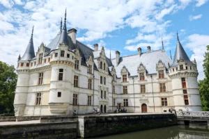 Azay‑le‑Rideau castle beside reflective moat under blue sky
