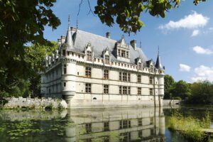 Azay‑le‑Rideau chateau reflected in calm moat under blue sky