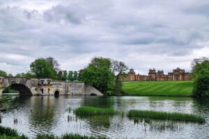 Blenheim Palace beside lake and Palladian bridge
