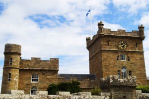 Culzean Castle stone towers, clock tower, Scottish flag