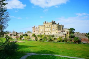 Culzean Castle overlooking gardens and sea under blue sky