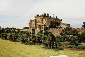 Culzean Castle above gardens and walled ramparts under a pale sky