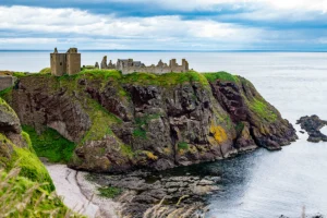 Dunnottar Castle ruins atop rugged coastal cliffs overlooking the North Sea