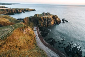 Aerial view of Dunnottar Castle on rugged sea cliffs