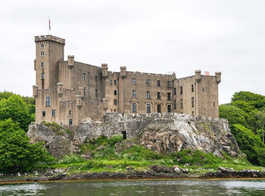 Dunvegan Castle perched on rocky promontory above water