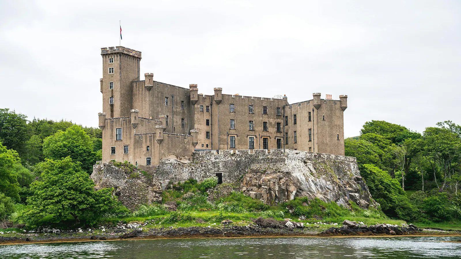 Dunvegan Castle perched on rocky promontory above water