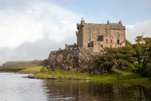 Dunvegan Castle perched on rocky promontory by water