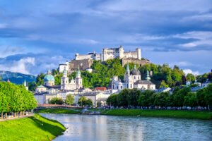 View of Fortress Hohensalzburg above Salzburg skyline and Salzach River