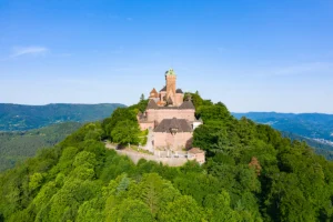 Aerial view of Haut-Koenigsbourg Castle on a forested hilltop