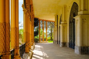 Hluboka Castle colonnade with carved columns and iron spiral staircase