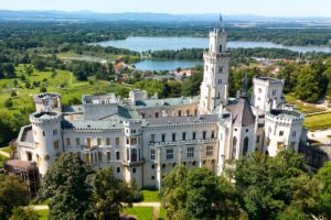 Aerial view of Hluboka Castle with lakes and forests
