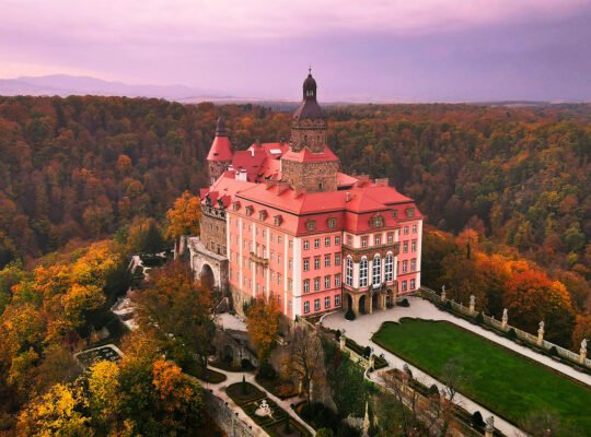 Aerial view of Ksiaz Castle amid autumn forest