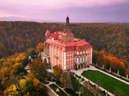 Aerial view of Ksiaz Castle amid autumn forest