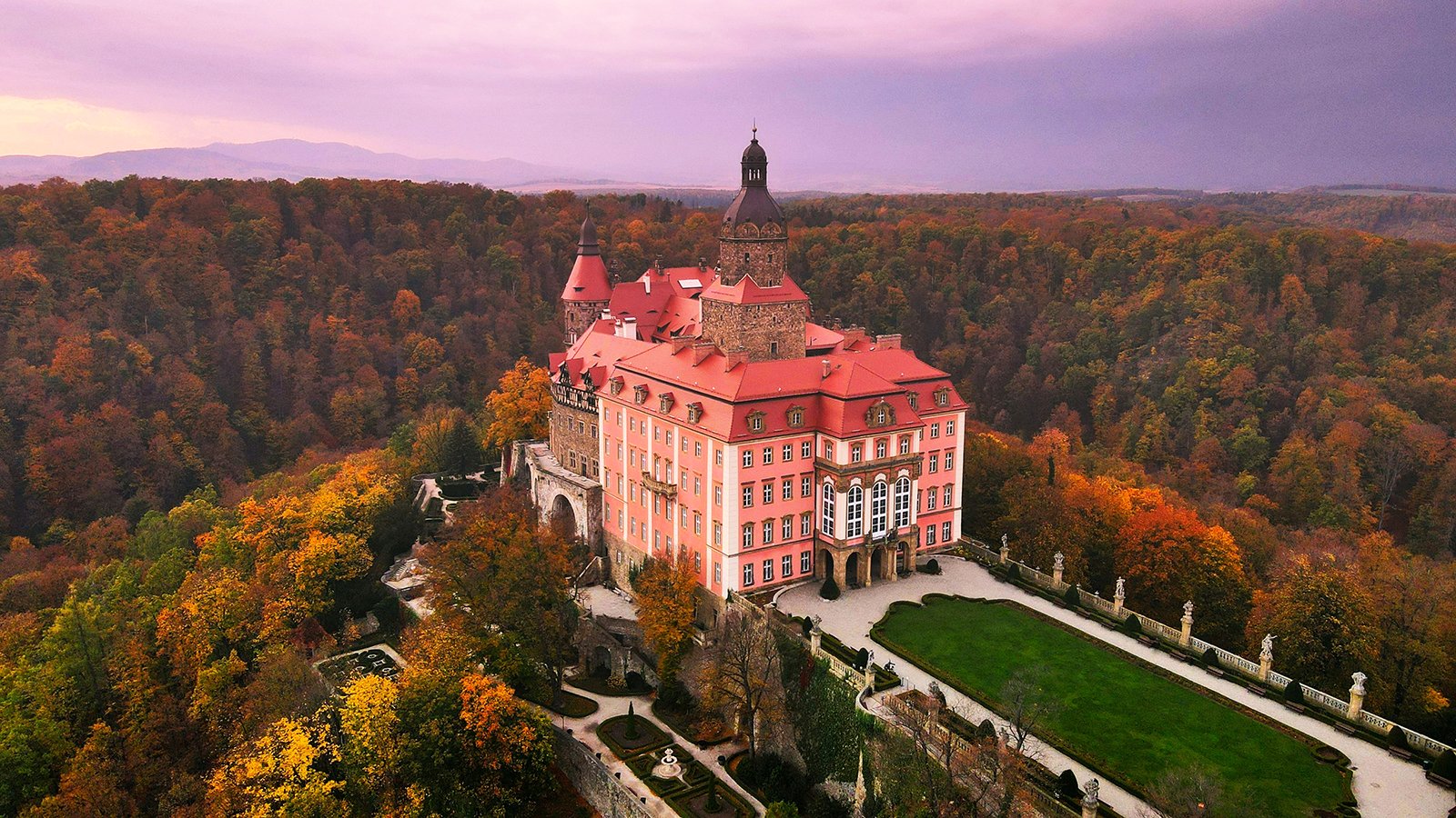 Aerial view of Ksiaz Castle amid autumn forest