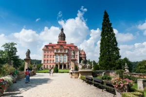 Front view of Ksiaz Castle with gardens and blue summer sky