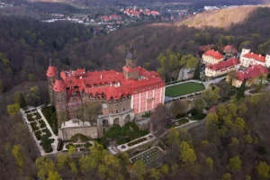 Aerial shot of Ksiaz Castle on hill with terraced gardens
