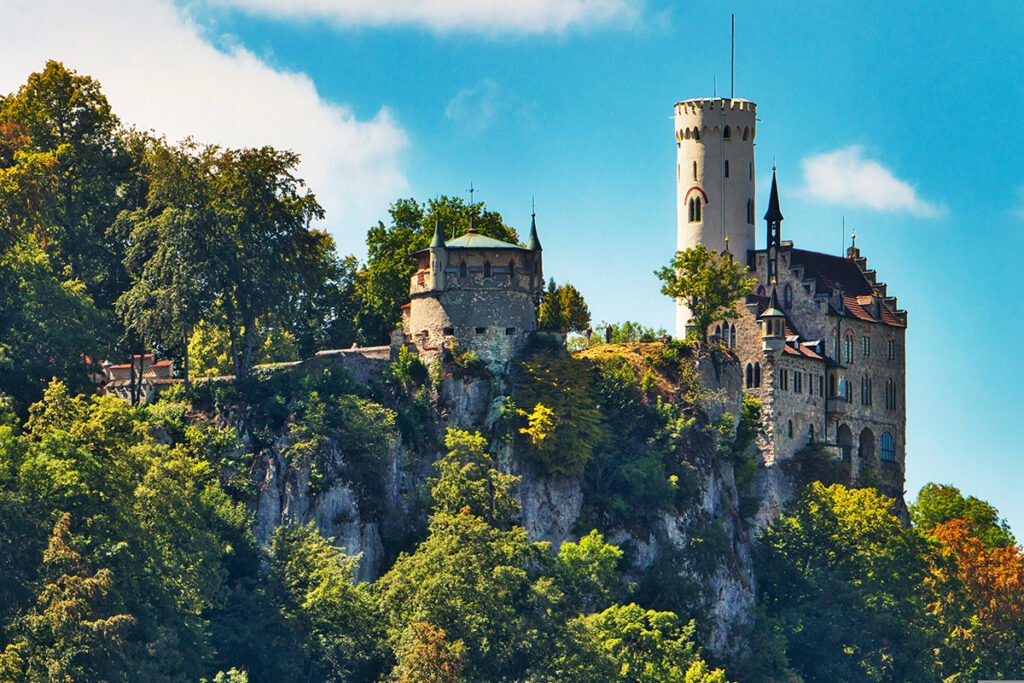 Lichtenstein Castle perched atop rocky forested cliff