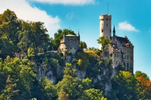 Lichtenstein Castle perched atop rocky forested cliff