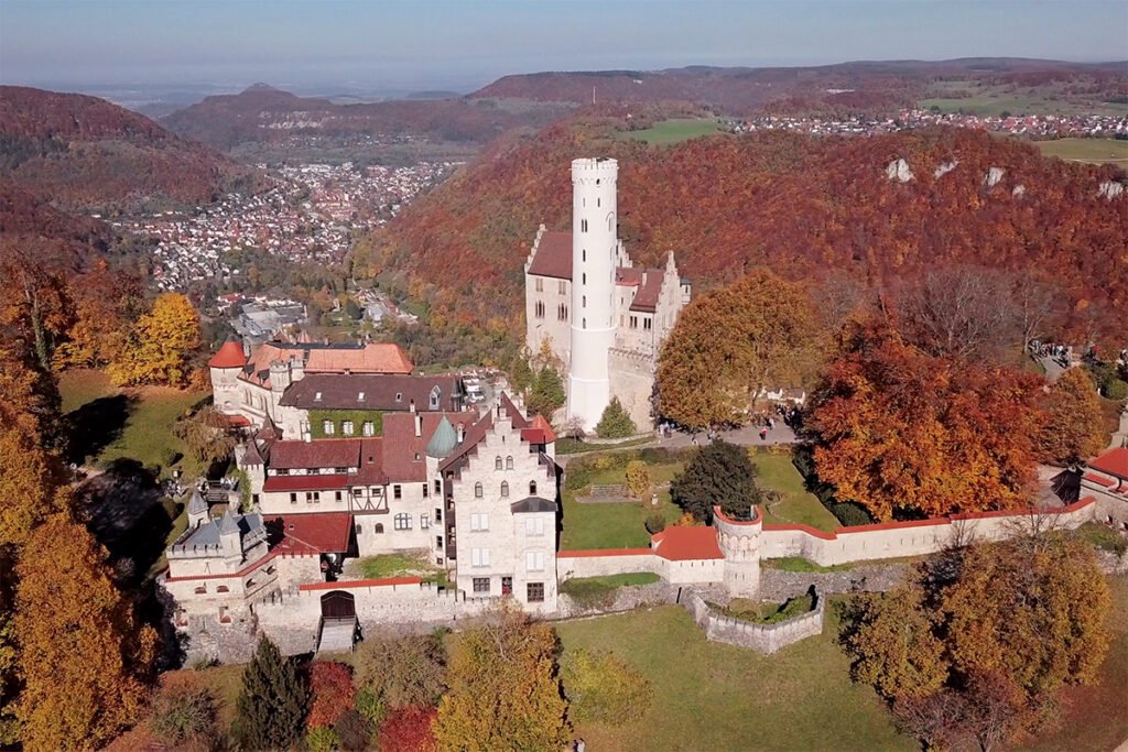 Aerial view of Lichtenstein Castle perched on a wooded cliff in autumn