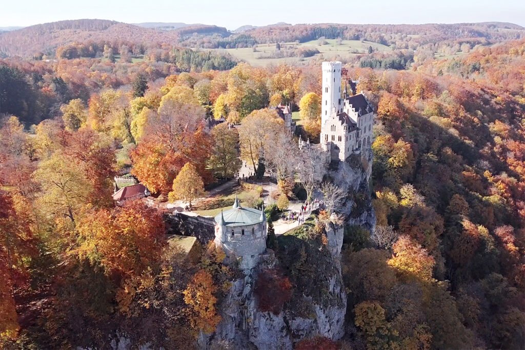 Lichtenstein Castle perched on rocky cliff in autumn