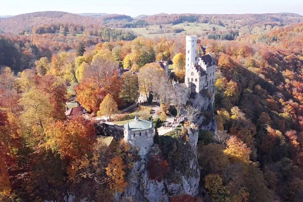 Lichtenstein Castle perched on rocky cliff in autumn