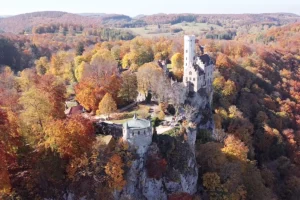 Lichtenstein Castle perched on rocky cliff in autumn