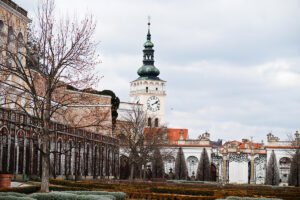 Mikulov Castle tower and ornate gates above trimmed winter gardens