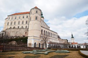 Mikulov Castle above manicured gardens under cloudy sky