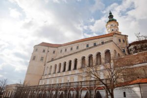 Mikulov Castle facade with arched terraces under cloudy sky