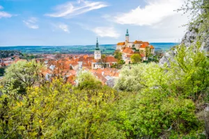 Panoramic view of Mikulov Castle and red-roofed town among spring greenery