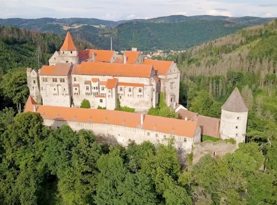 Aerial view of Pernstejn Castle perched in forested hills