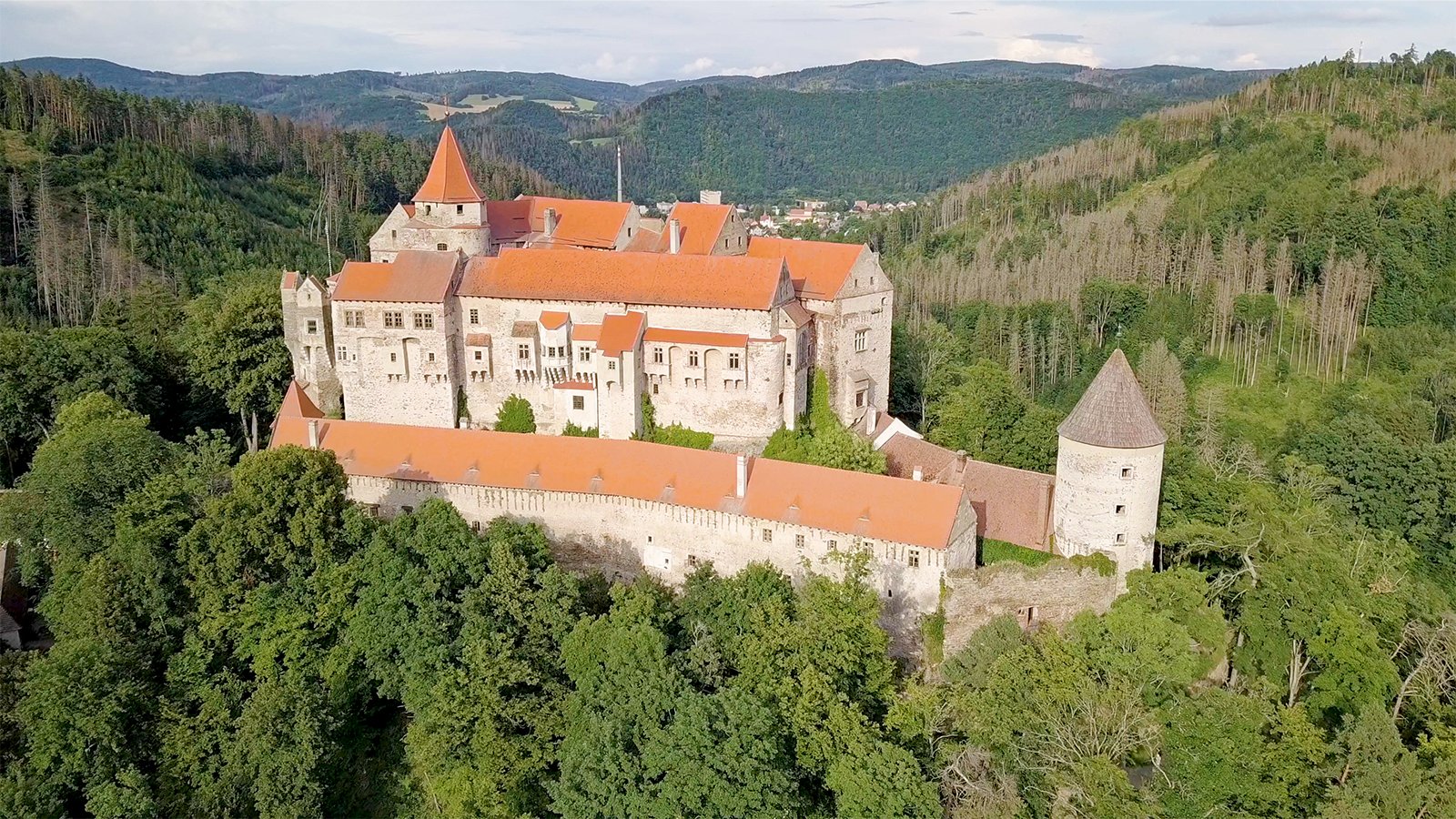 Aerial view of Pernstejn Castle perched in forested hills