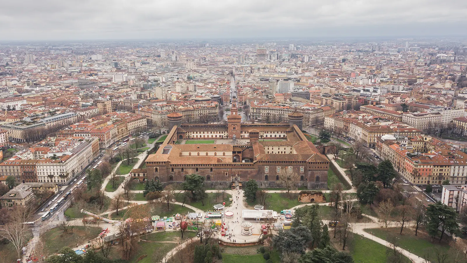 Aerial view of Sforzesco Castle surrounded by Milan rooftops