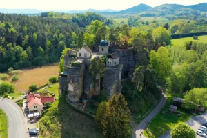 Aerial view of Sloup Castle atop sandstone rock towers