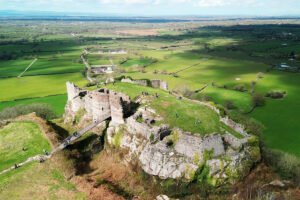 Aerial view of Beeston Castle ruins on rocky hilltop