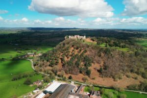 Aerial view of Beeston Castle on wooded sandstone hill