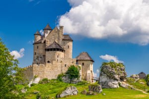 Bobolice Castle perched on limestone outcrop under blue sky