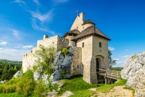 Bobolice Castle above green forest on limestone rocks