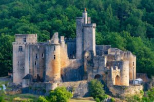 Bonaguil Castle perched among lush forested hills