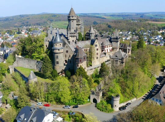 Aerial view of Braunfels Castle on wooded hill above town