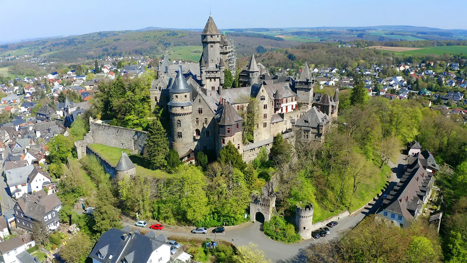 Aerial view of Braunfels Castle on wooded hill above town