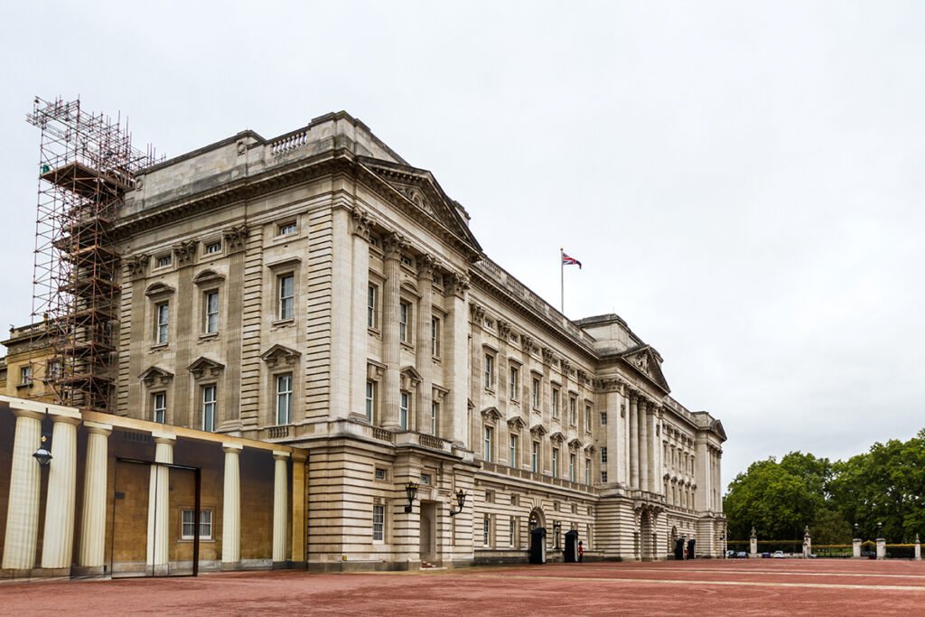 Buckingham Palace exterior with Union Flag and red forecourt