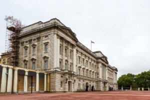 Buckingham Palace exterior with Union Flag and red forecourt