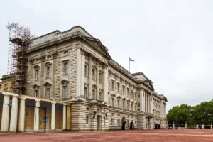 Buckingham Palace exterior with Union Flag and red forecourt