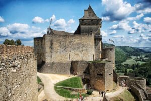 View of Château de Castelnaud overlooking the Dordogne valley from stone battlements