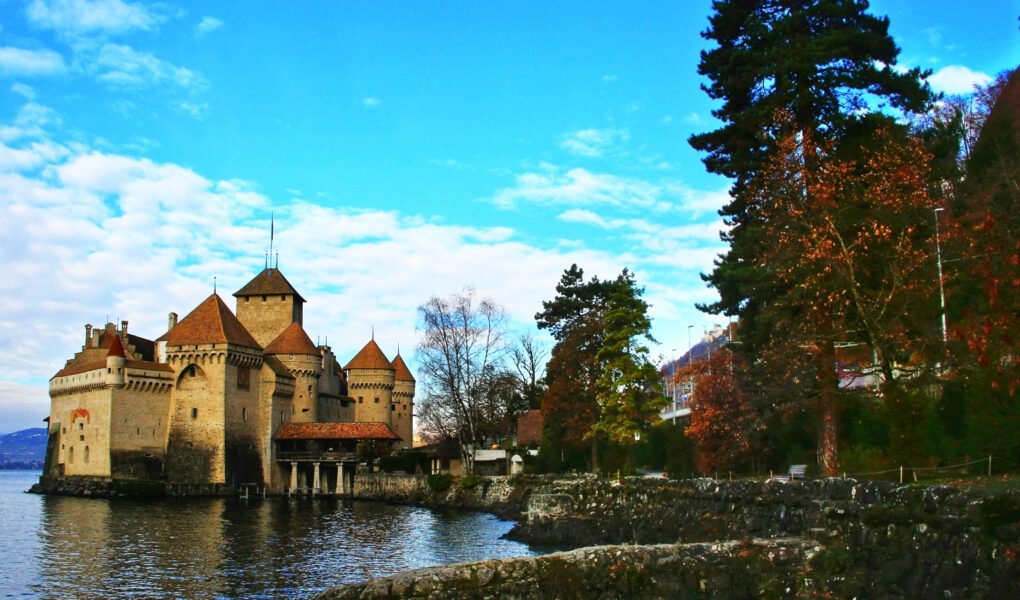 Chillon Castle by tranquil lake with towers