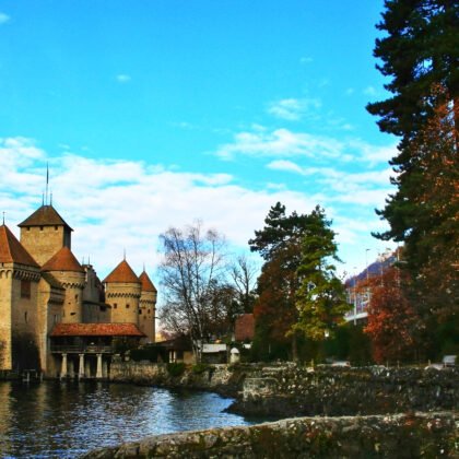 Chillon Castle by tranquil lake with towers