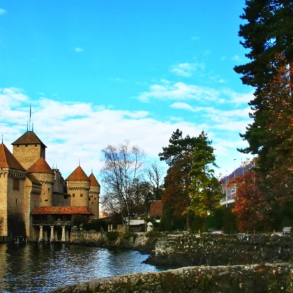 Chillon Castle by tranquil lake with towers
